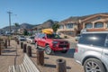 Beach street view, cars with kayaks mounted on top. Shell Beach is a best spot along the coast for diving and kayaking