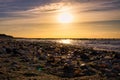 Shell beach by the sea on the Baltic Sea. Sunset, groynes in the background. Coast