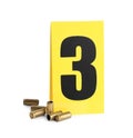 Shell casings and crime scene marker with number three isolated on white Royalty Free Stock Photo