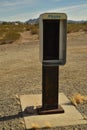 Empty telephone booth in desert outdated technology