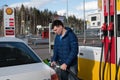 Shell gas station man fills car with gasoline Royalty Free Stock Photo