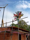 Shell of a house with decorated tree on the roof