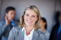 Shell never stop climbing the leader to success. a confident businesswoman standing in front of her team at the office. Royalty Free Stock Photo