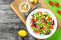 Shell pasta delicious salad with mixed lettuce leaves, salami on the white dish with nuts, honey and sesame seeds sauce Royalty Free Stock Photo