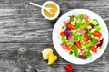 Shell pasta delicious salad with mixed lettuce leaves, salami on the white dish with nuts, honey and sesame seeds sauce Royalty Free Stock Photo