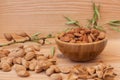 Shell and peeled almonds in wooden bowl with a tree brunch Royalty Free Stock Photo