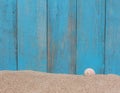 Shell on sand against a old wooden background