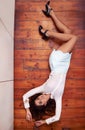 Shell spin your world upside down. Full length high angle shot of an attractive young woman lying on a hard wood floor. Royalty Free Stock Photo