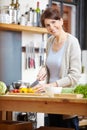 Shell wow you with her cooking. an attractive woman chopping vegetables at a kitchen counter. Royalty Free Stock Photo