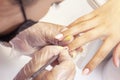 Shellac coating master applies nail polish to client