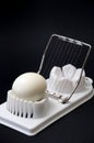 Shelled boiled egg on a white chopper and black background Royalty Free Stock Photo