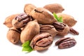 Shelled and cracked pecan nuts with leaves close-up on white background