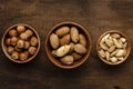 Shelled hazelnut almonds pecan nuts in bowl on wooden table background Royalty Free Stock Photo
