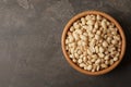 Shelled peanuts in bowl and space for text on table Royalty Free Stock Photo