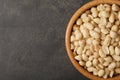 Shelled peanuts in bowl and space for text on table Royalty Free Stock Photo