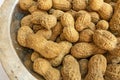 Shelled peanuts in metal bowl Royalty Free Stock Photo