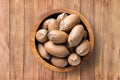 Shelled pecan nuts raw in bowl on wooden table background, top view. organic vegetarian food Royalty Free Stock Photo