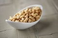 Shelled pine nuts in a white bowl