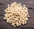 Shelled pine nuts on the wooden table. Top view. Organic food Royalty Free Stock Photo