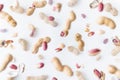 Shelled and in shell peanuts flying above white background, levitation effect