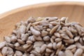 Shelled sunflower seeds on a wooden bowl against a white background. Food. Spices Royalty Free Stock Photo