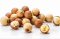 Shelled and unshelled macadamia nuts, cut out on white background
