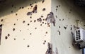 Shelled wall of a residential building. Consequences of the war in the Donbas. Housing stock of the DPR. Holes from fragments of a