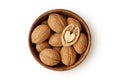 Shelled walnuts with half heart shaped walnut in wooden bowl on white background Royalty Free Stock Photo