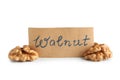 Shelled walnuts with paper card on white background