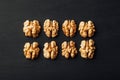 Shelled walnuts in a row on black Royalty Free Stock Photo