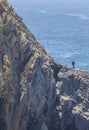 Shellfish catcher ascending the cliff