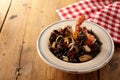 Shellfish gourmet risotto nero meal in bowl beside napkin