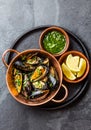 Shellfish Mussels in copper bowl, lemon, herbs sauce.