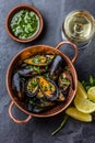 Shellfish Mussels in copper bowl, lemon, herbs sauce.