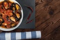 Shellfish seafood. Hot fresh italian appetizing steamed mussels in tomato sauce with olives and red pepper on vintage wooden table