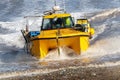 Shellfishing boat returning for a beach landing after trip at sea.