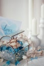 Shells, blue and white crystals in a glass box, candles