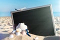 Shells pattern. Globe, seashell, airplane and starfish near black desk on sea beach in sunny day. Copy space of summer vacation Royalty Free Stock Photo