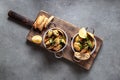 Shells vongole venus clams with cilantro in dish on gray background. Royalty Free Stock Photo