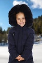 Sheltered girl with black coat in a cold and snowed day