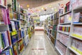 Shelves with books in a bookstore. Large selection of diverse literature. On the floor there is a marking for buyers to observe