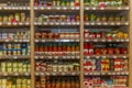 Shelves with canned foods in the supermarket. Blurred Royalty Free Stock Photo