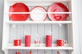 Shelves with dishes. Interior light grey kitchen and red christmas decor. Preparing lunch at home on the kitchen concept Royalty Free Stock Photo
