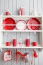 Shelves with dishes. Interior light grey kitchen and red christmas decor. Preparing lunch at home on the kitchen concept Royalty Free Stock Photo