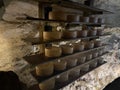 Shelves full of cabrales cheeses in the process of maturation inside a cave, traditional cheese curing