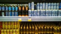 Shelves with glass bottles and cans of Russian brand Baltika beer. Alcohol in supermarket. Food and wine shop. Retail industry.