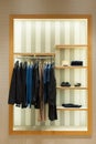 Shelves and hangers with men`s clothing and shoes Royalty Free Stock Photo
