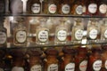 Shelves with medicines glass bottles in the old pharmacy. Soft focus blur background