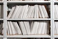 shelves with paper documents. Organized office space with neatly arranged paper documents and file cabinets