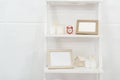 Shelves with red clock, wooden frameworks and candles